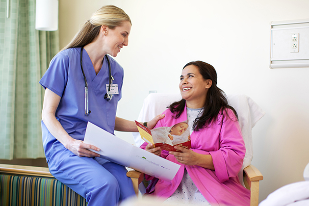 Smiling nurse with female patient