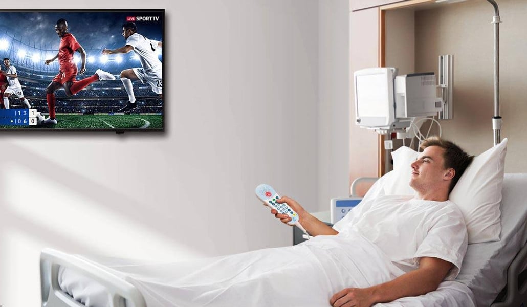 Male patient watching TV Screen in hospital room